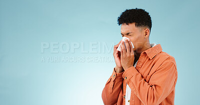 Buy stock photo Man, blowing and nose for sinus in studio for healthcare mock up on blue background in Cape Town. Male model, hand and tissue for hay fever, flu or congestion for allergies with announcement in space