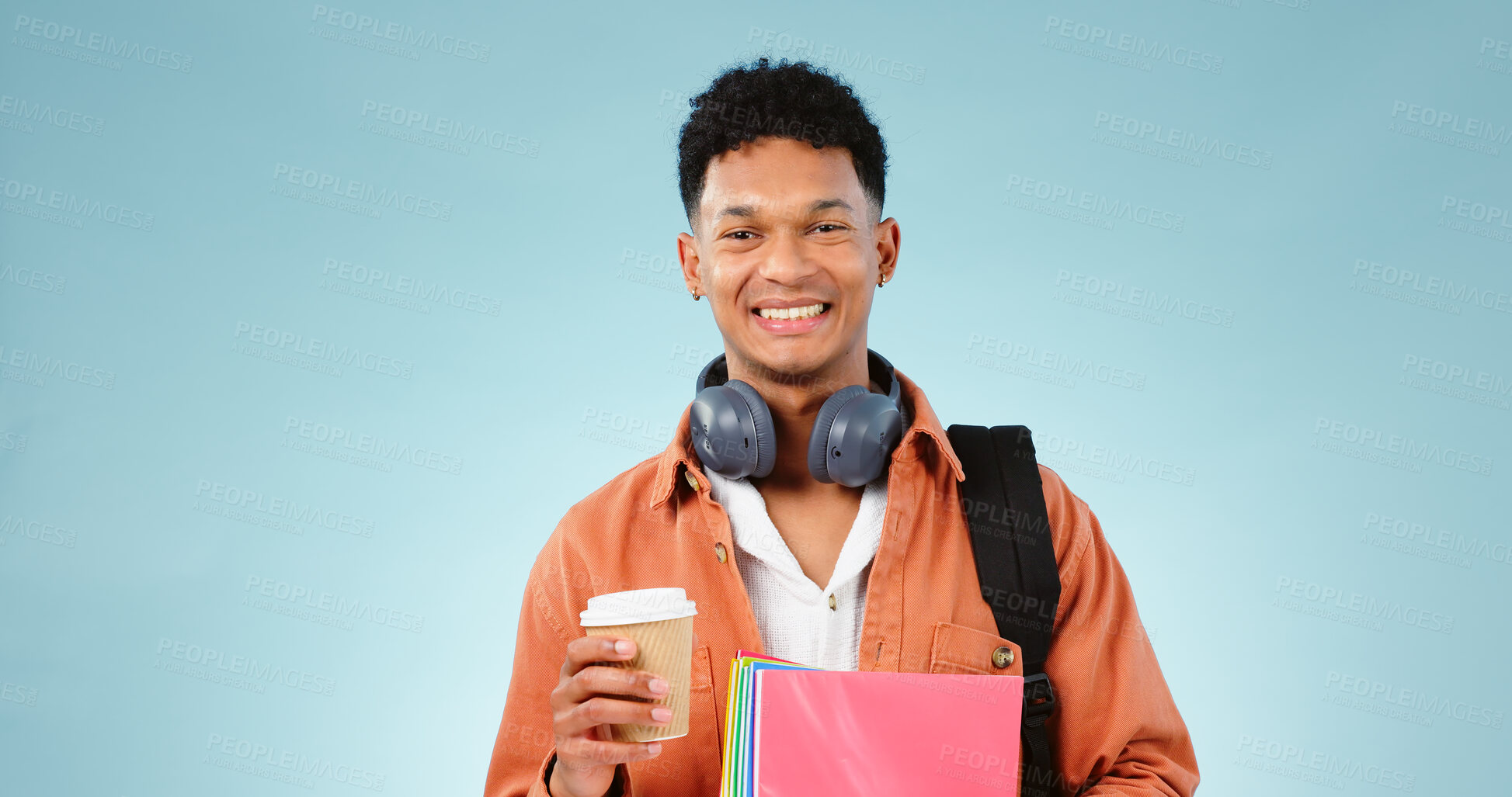 Buy stock photo Student, coffee and portrait of man with books and backpack in studio for university or college. Education, happy and person smile with headphones, notebooks and bag for learning on blue background