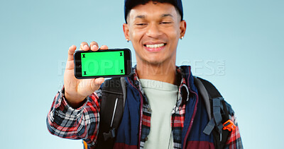 Buy stock photo Hiking, green screen and man with a cellphone, smile and happiness on a blue studio background. Person, hiker and model with adventure, mockup space or smartphone with tracking markers or digital app