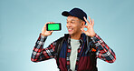 Hiking, green screen and man with a smartphone, ok sign and happiness on a blue studio background. Person, hiker and model with perfect symbol, agreement and cellphone with tracking markers and smile