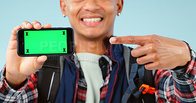 Buy stock photo Hands, point and phone with green screen in studio for hiking app, travel mockup and space by blue background. Person, smartphone and chromakey with tracking markers, promotion and user experience