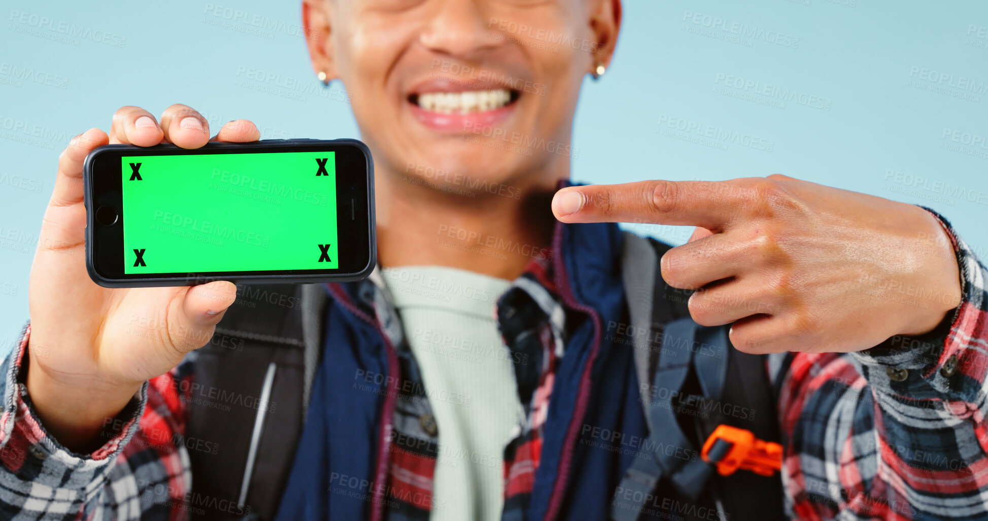 Buy stock photo Hands, point and phone with green screen in studio for hiking app, travel mockup and space by blue background. Person, smartphone and chromakey with tracking markers, promotion and user experience