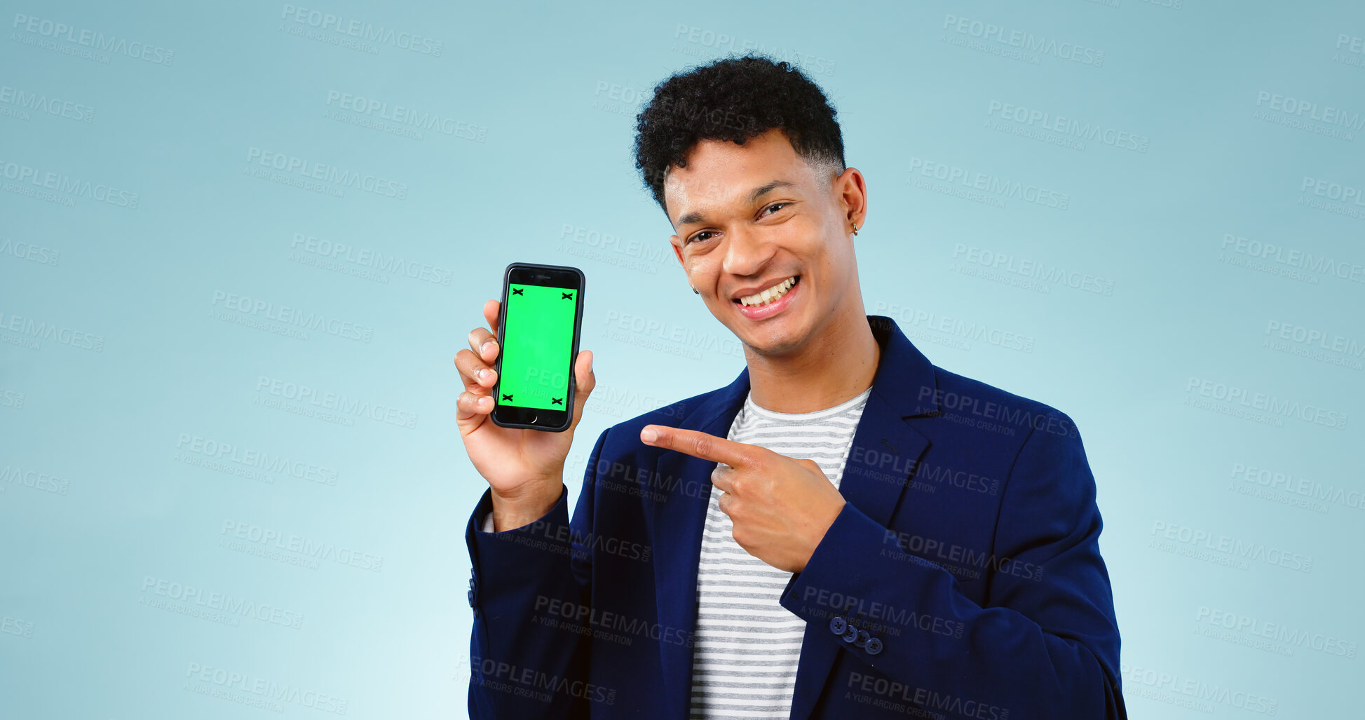 Buy stock photo Happy man, pointing and phone for green screen on blue background in studio, portrait and mockup in New York. Male model, entrepreneur or creative with mobile of offer, promotion or discount on web