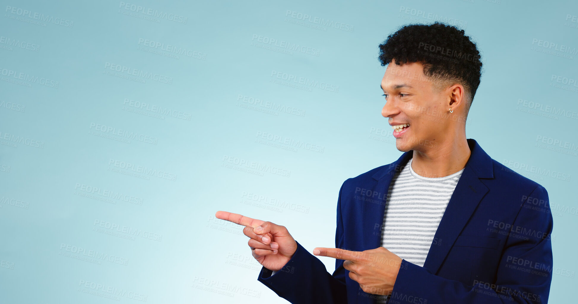 Buy stock photo Mockup, smile and a business man pointing to information on a blue background in studio for marketing. Space, banner and announcement message with a happy young employee in a suit for advertising