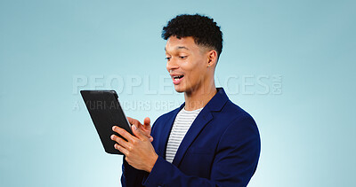 Buy stock photo Happy man in studio, reading on tablet for business email and research for creative startup schedule. Thinking, wow and professional with digital app, notification and social media on blue background