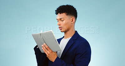 Buy stock photo Man in studio, writing in notebook for ideas and business research for creative startup schedule. Thinking, agenda and young professional businessman with notes, pen and to do list on blue background