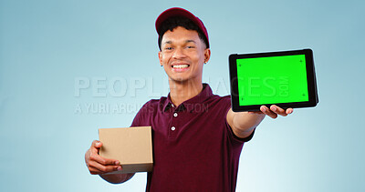 Buy stock photo Delivery person, tablet and green screen in studio for smile, mockup space and box by blue background. Courier man, cardboard package and portrait for app promotion, chromakey and tracking markers