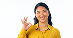 Portrait, smile and okay with a young asian woman isolated on a white background in studio looking confident or positive. Face, happy and perfect with a korean girl in a casual clothes outfit