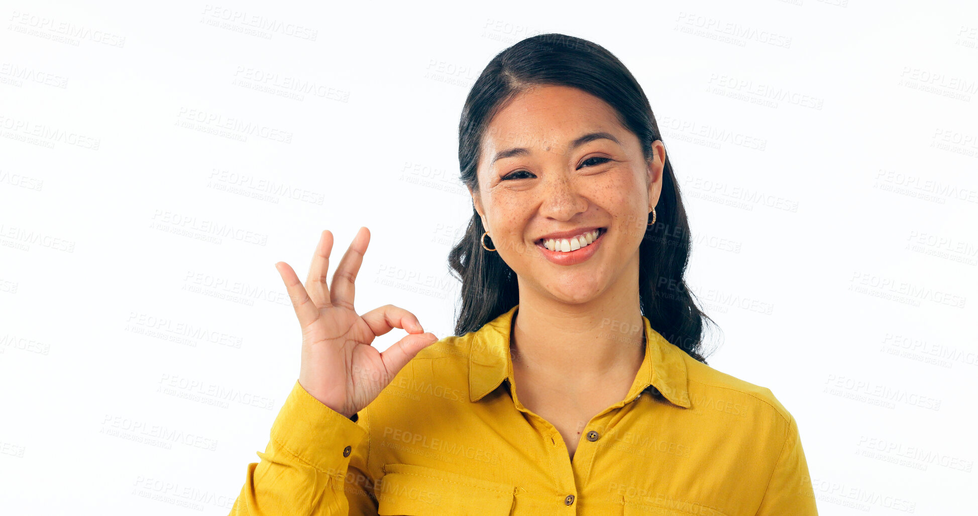 Buy stock photo Portrait, smile and okay with a young asian woman isolated on a white background in studio looking confident or positive. Face, happy and perfect with a korean girl in a casual clothes outfit