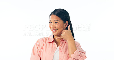 Buy stock photo Portrait, woman and smile for call me, hand sign and communication in studio on white background. Happy asian model, talk and emoji gesture for telephone chat, conversation and contact for networking