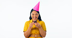 Birthday party, chocolate and an asian woman eating a cupcake in studio isolated on a transparent background for celebration. Smile, hat and a happy young person with a dessert or snack at an event