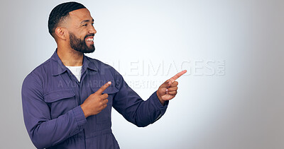 Buy stock photo Happy man, pointing and mockup space for advertising or marketing against a studio background. Male person or salesman smile showing deal, list or information for advertisement, notification or alert