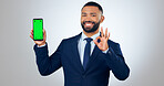 Phone, green screen portrait of and business man with okay sign in studio for approve, website and social media. Corporate, hand gesture and person on smartphone for mobile app on gray background