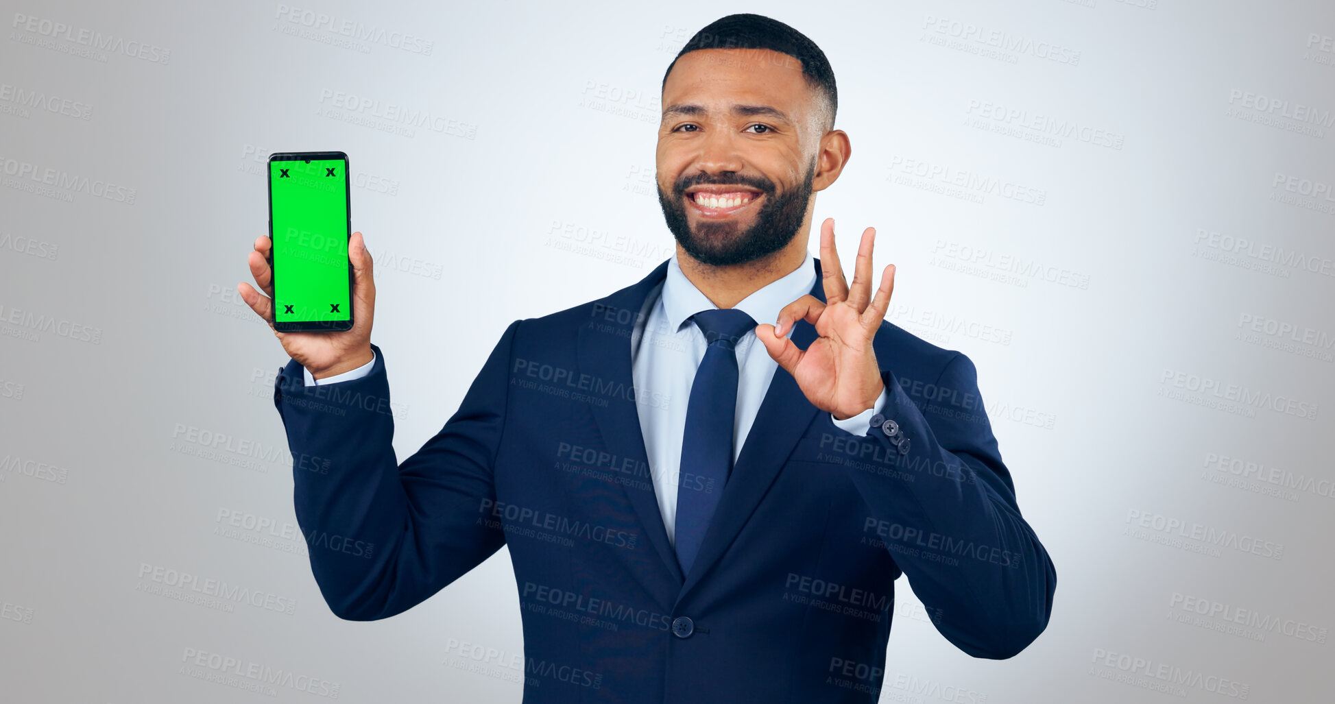 Buy stock photo Phone, green screen portrait of and business man with okay sign in studio for approve, website and social media. Corporate, hand gesture and person on smartphone for mobile app on gray background