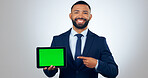 Tablet, green screen and portrait of business man in studio for internet, website promotion and social media. Corporate, professional and person on digital tech for networking on gray background