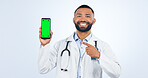 Phone, green screen and portrait of doctor pointing to promo or registration in white background. Studio, healthcare or sign to offer, information or telehealth mobile app, services or presentation