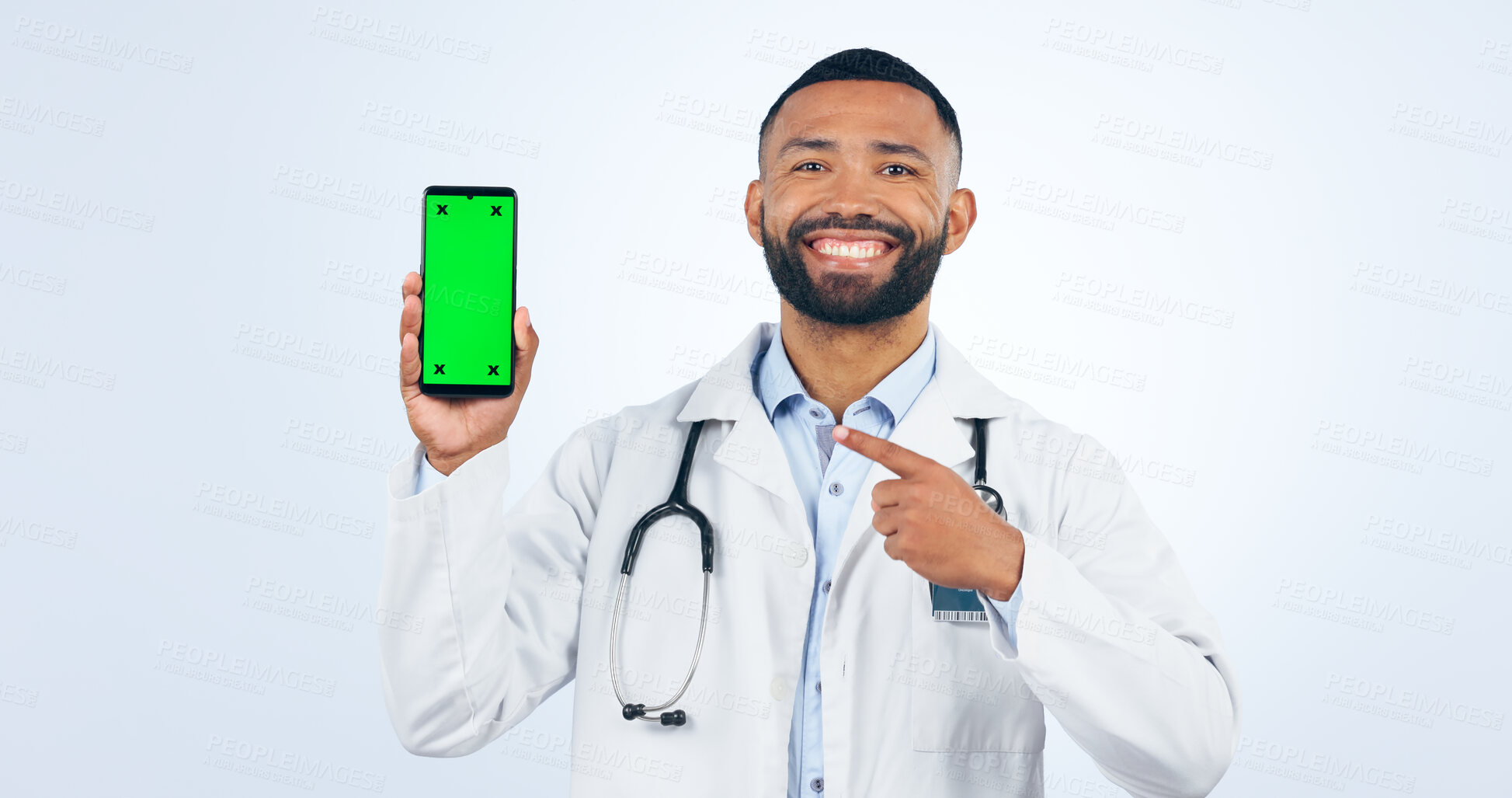 Buy stock photo Phone, green screen and portrait of doctor pointing to promo or registration in white background. Studio, healthcare or sign to offer, information or telehealth mobile app, services or presentation