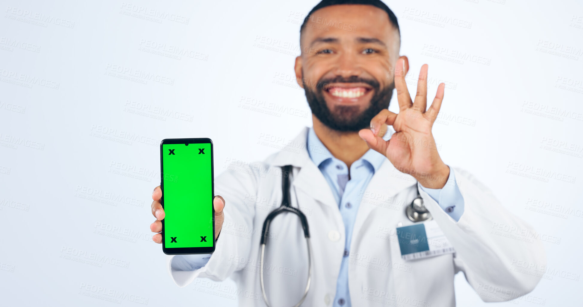 Buy stock photo Phone, okay sign and portrait of doctor with green screen agreement or registration in white background. Studio, healthcare or hand for ok, yes and mobile app success for telehealth services mockup