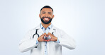 Portrait, doctor with heart hands and smile in studio for care, kindness and trust icon in healthcare. Support, love emoji and help medical professional man showing happiness on white background.