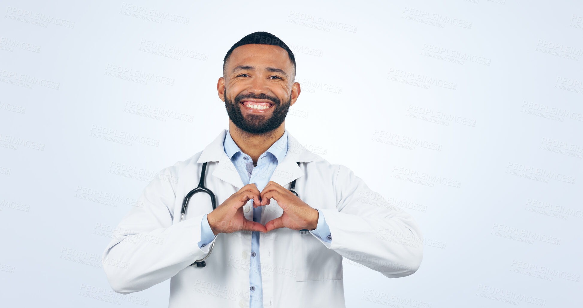 Buy stock photo Portrait, doctor with heart hands and smile in studio for care, kindness and trust icon in healthcare. Support, love emoji and help medical professional man showing happiness on white background.