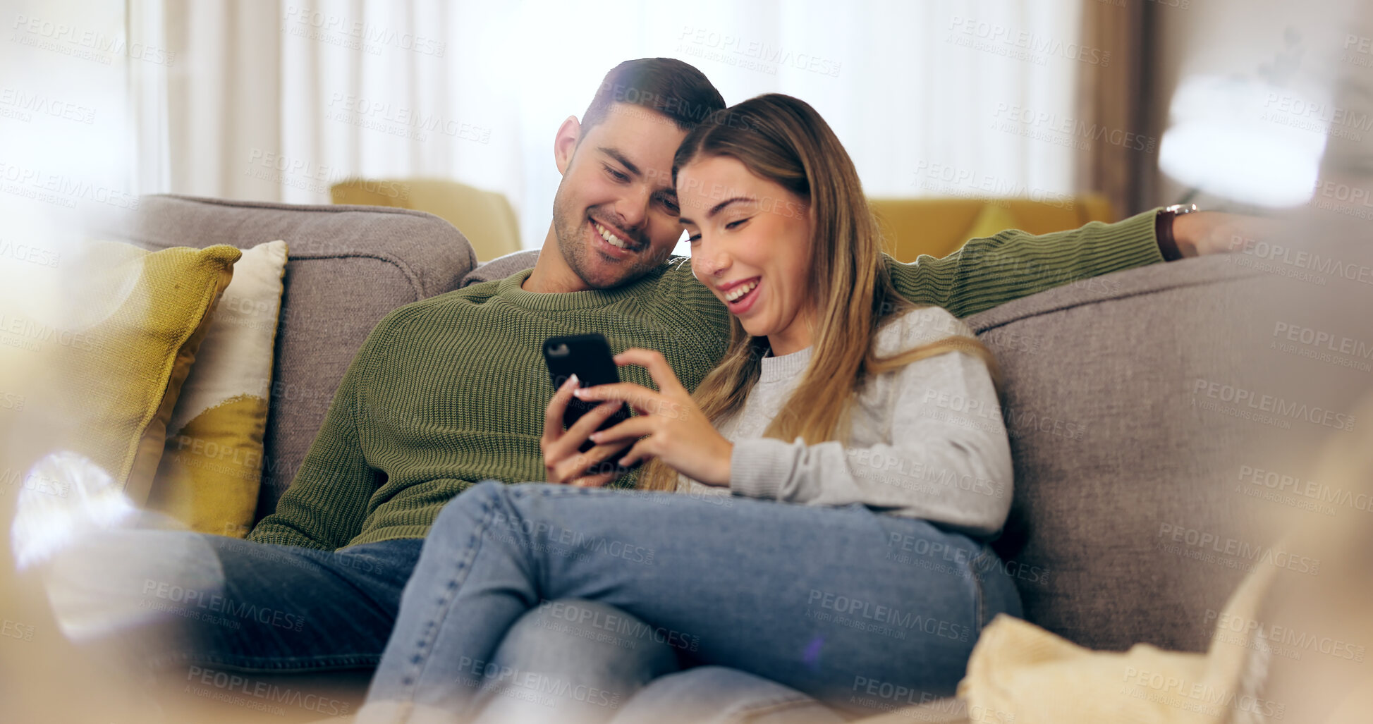 Buy stock photo Relax, phone and couple on sofa for social media, internet and reading funny website together. Dating, home and man and woman on smartphone laugh for meme and bonding, happy and love in living room