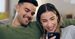 Happy, phone and couple on sofa for social media, internet and reading funny website together. Dating, home and man and woman on smartphone laugh for meme and bonding, relax and love in living room