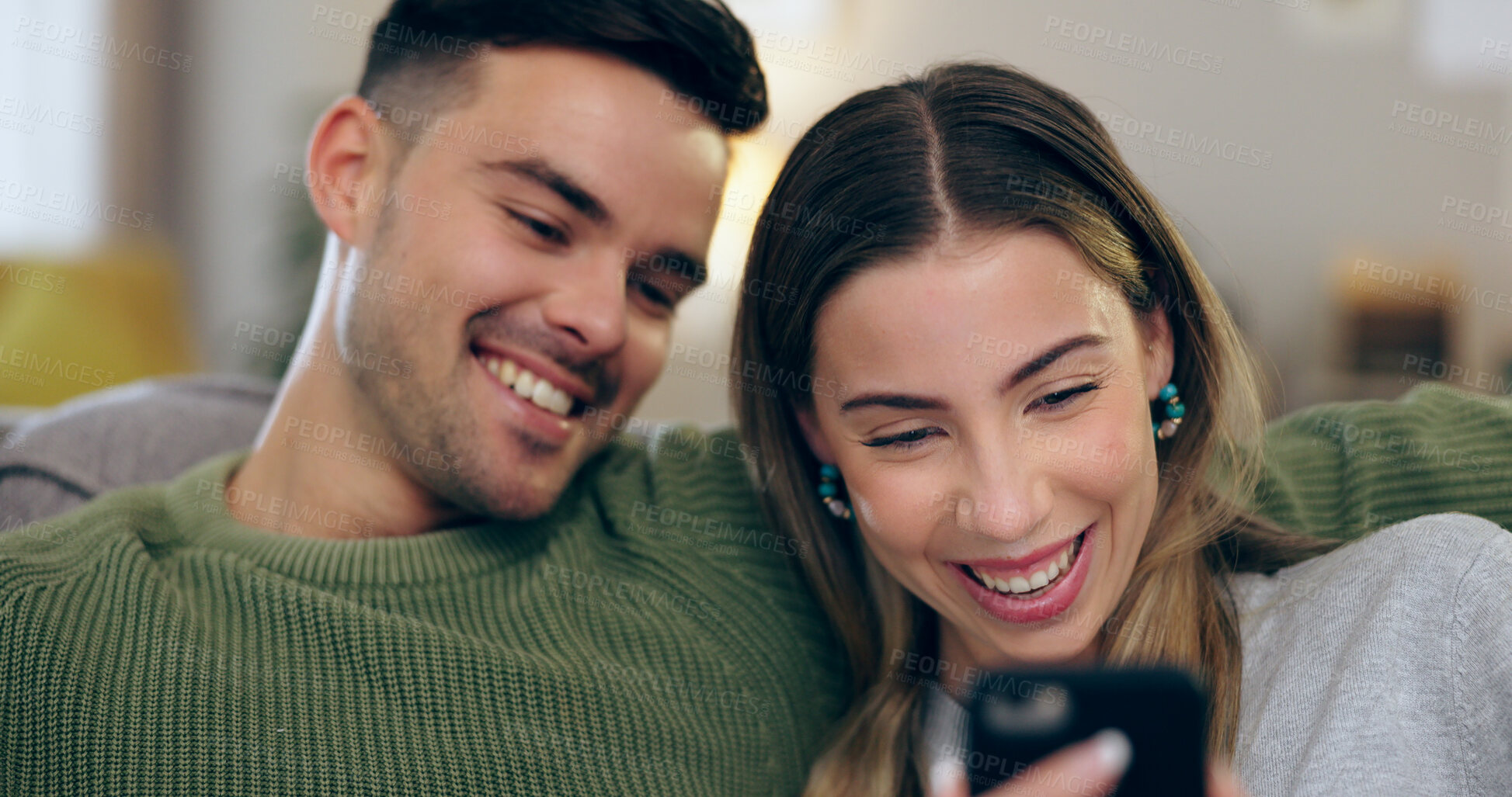 Buy stock photo Happy, phone and couple on sofa for social media, internet and reading funny website together. Dating, home and man and woman on smartphone laugh for meme and bonding, relax and love in living room