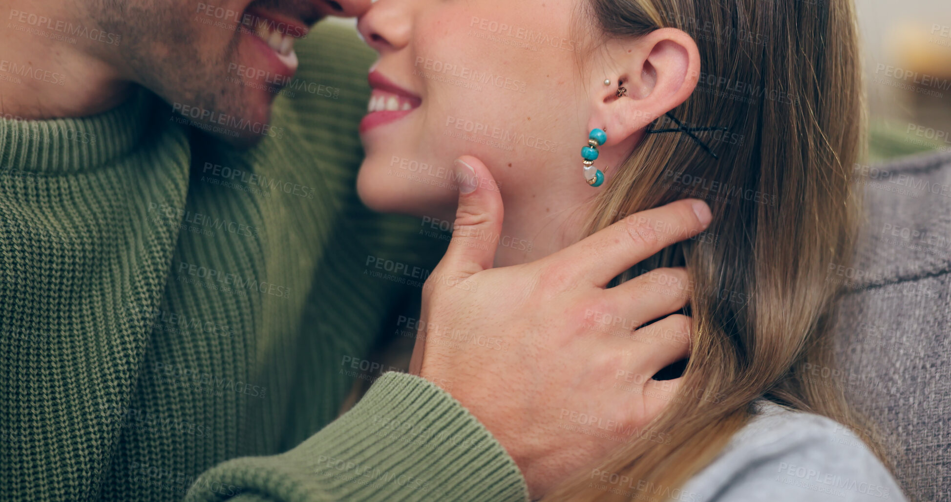 Buy stock photo Closeup, couple and hand for kiss in romance on sofa in home with smile for affection by touch. Happy man, woman or married with love, trust or care in bond on honeymoon for wellness in relationship