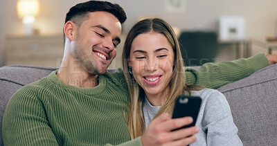 Buy stock photo Happy, love and couple  with phone on sofa for social media, internet and reading funny website together. Dating, home and man and woman on smartphone for bonding, relax and laugh in living room