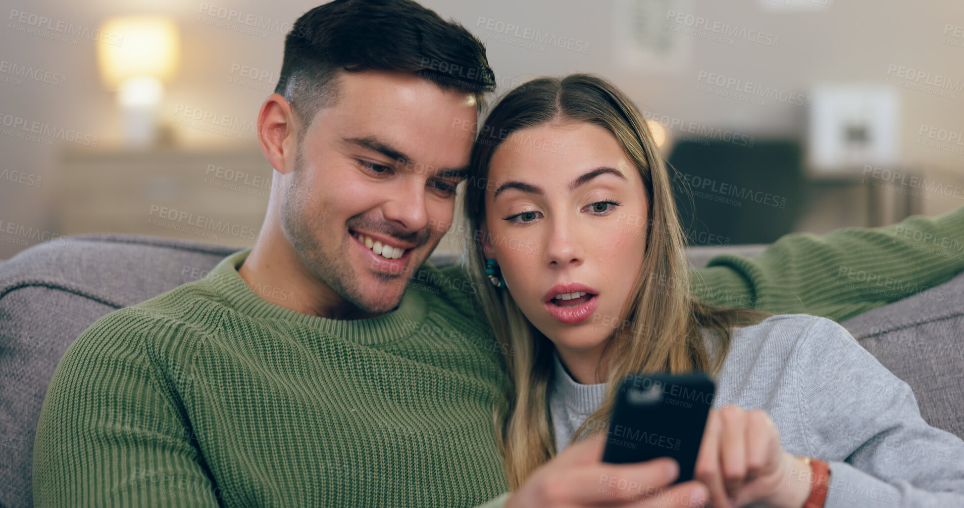 Buy stock photo Reading, phone and couple on sofa for social media, internet and browse website together. Dating, home and man and woman on smartphone for online chat and bonding, relax and love in living room