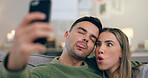 Couple, sofa and selfie with funny face in home living room with cross eyes, tongue and together for web blog. Man, woman and comic memory with photography for profile picture on social network app