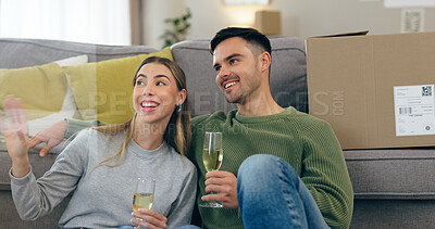 Buy stock photo Happy couple, celebration and champagne for moving home or new property, drink in living room. Man, woman and wine glass for achievement in apartment boxes for change or floor chat, cheers at sofa