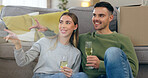 Couple, move and celebration champagne or boxes talking for pointing furniture or living room, chat or happy. Man, woman and new property cheers drink for apartment change achievement, toast or relax