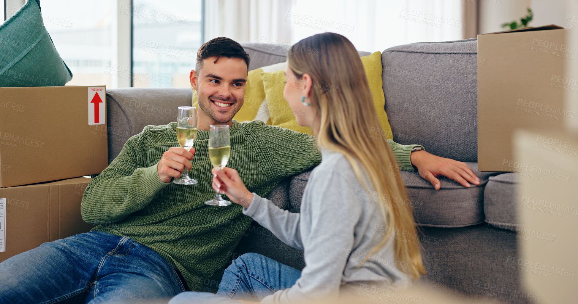Buy stock photo Couple, moving and home celebration with champagne drink at new property living room, boxes or future. Man, woman and wine glass as achievement happy or apartment change or milestone, cheers at sofa