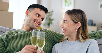 Buy stock photo Couple, new home and toast champagne on sofa for celebration with boxes in living room together. Man, woman and wine glass with cheers, achievement and investment in real estate, property or house