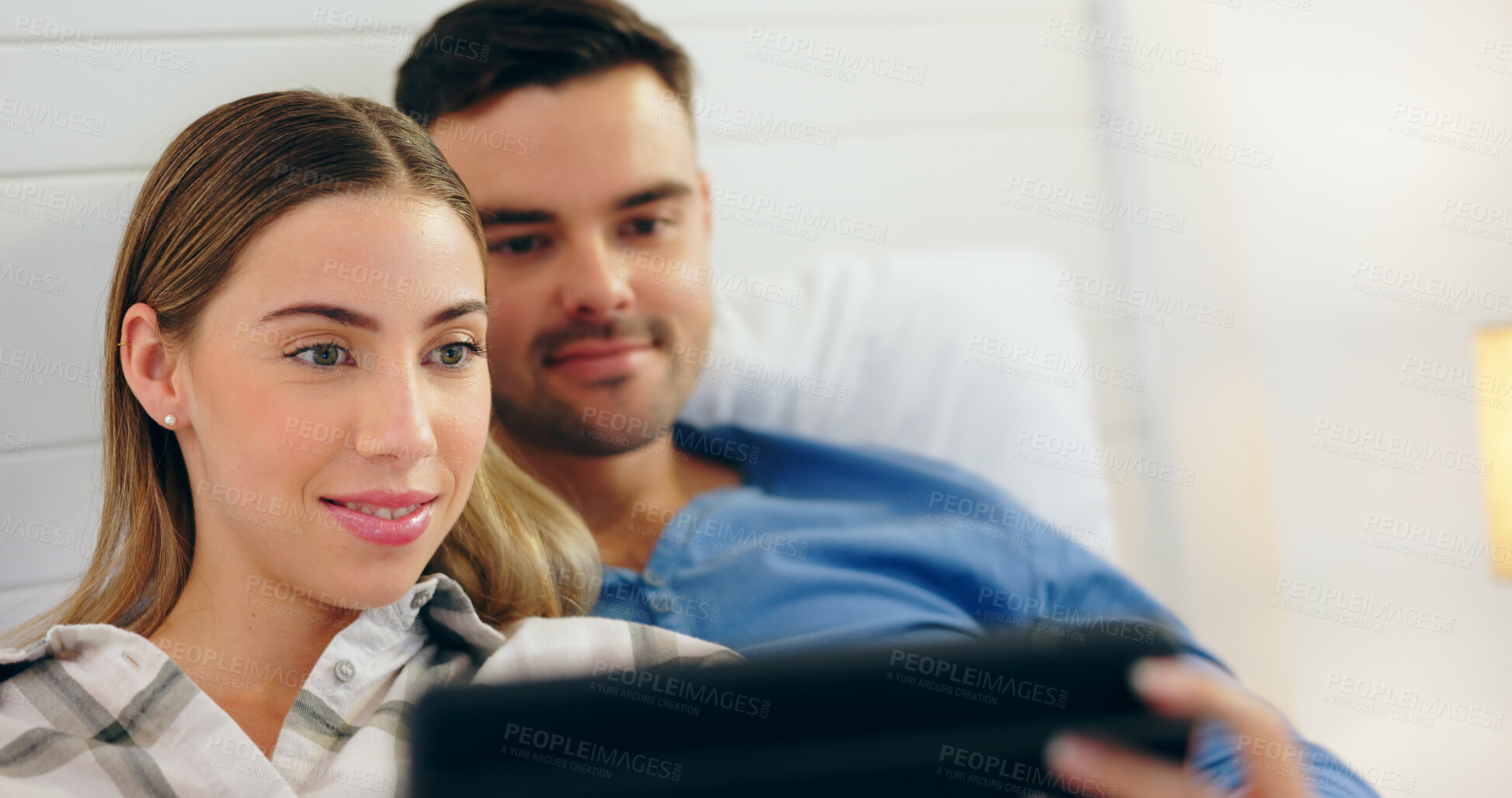 Buy stock photo Tablet, love and a young couple in the bedroom of their home together to relax in the morning of a weekend. Technology, social media or streaming with a happy man and woman bonding in bed for rest