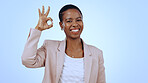 Space, portrait or black woman with okay hand sign for support, agreement or feedback. Studio, happy or business person on blue background with smile or perfect gesture for approval, like or yes