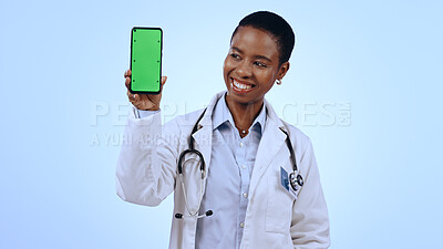 Buy stock photo Green screen, black woman and doctor with a smartphone, smile and healthcare on blue background. African person, medical or professional with a cellphone, tracking markers and promotion with medicare