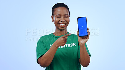 Buy stock photo Woman, volunteer and phone green screen, presentation mockup and support, join us or marketing in studio. Happy African person pointing to mobile, information and NGO volunteering on blue background