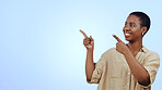 Woman, smile and pointing for announcement in studio with hands, presentation or advertising space. Black person, face and happy for marketing, showing deal or discount with pride and joy on mockup