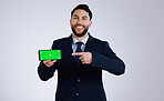 Professional man, phone green screen and presentation for website, corporate software or job registration in studio. Portrait of business worker pointing to mobile app or mockup on a white background