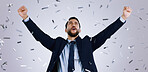 Happy businessman, fist pump and confetti in celebration, winning or achievement against a gray studio background. Excited man employee in party prize, good news or business promotion for success