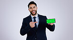 Business man, phone green screen and pointing to presentation, announcement or news in studio. Portrait of corporate worker with mobile app, career opportunity or website mockup on a white background