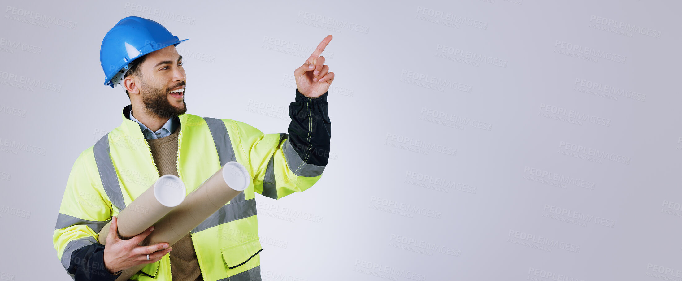 Buy stock photo Smile, pointing and man engineer with blueprint in studio with mockup space for advertising. Happy, marketing and male industrial worker with architect design and show hand gesture by gray background