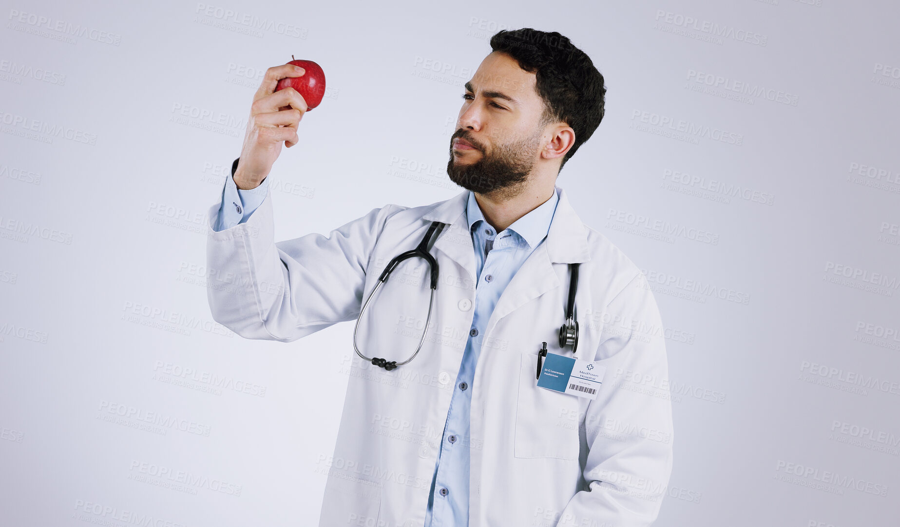 Buy stock photo Healthcare, doctor and thinking with apple in studio for mockup in nutrition on white background. Mexican person, male model or medical professional by red fruit in vegan, vegetarian or diet in space