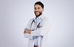 Happy man, portrait and professional doctor with arms crossed against a gray studio background. Male person, medical or healthcare expert standing in confidence with smile for health and wellness