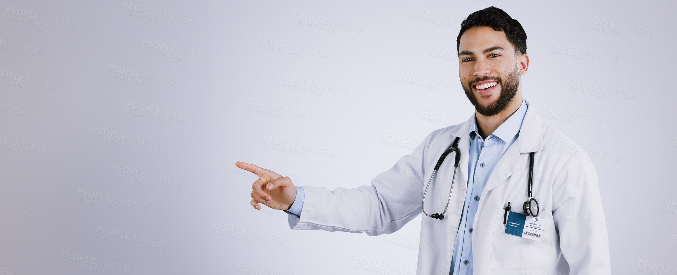 Buy stock photo Portrait, smile and doctor pointing at presentation, mockup or space on a white background. Face, happy medical professional advertising and announcement of info, healthcare man and marketing gesture