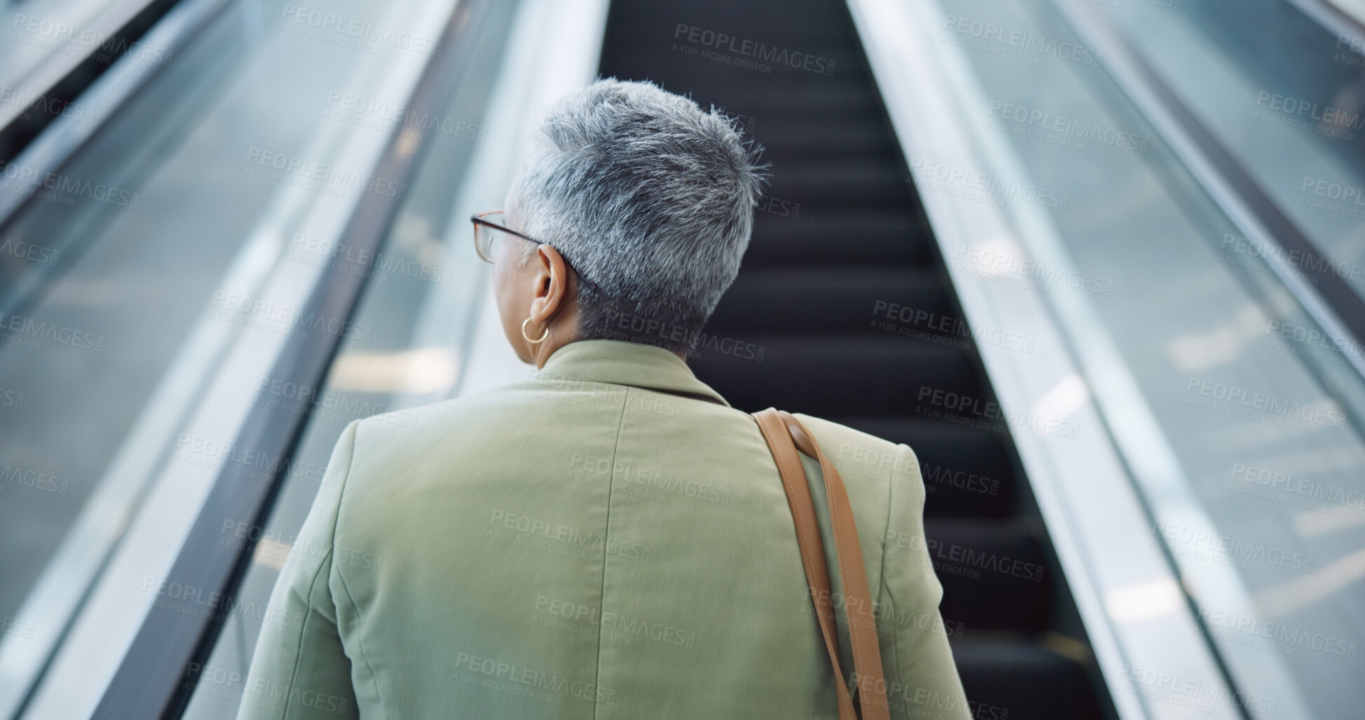 Buy stock photo Woman, back and travel on escalator in airport, building and thinking about work trip opportunity. Mature, businesswoman and walking with luggage and bag on stairs, steps or entrance in lobby