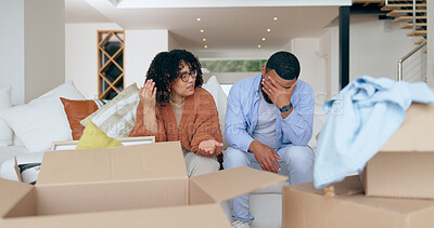 Buy stock photo New home, box and frustrated couple on sofa for house, property investment and moving day. Conflict, argue and man and woman with crisis, problem and fight for mortgage, rent and real estate purchase