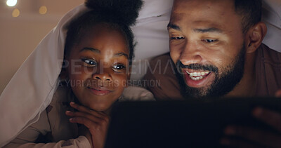 Father, daughter and tablet at night with internet for movie, cartoon or streaming with blanket on bed in bedroom. Family, man and girl child with technology in the dark for film, video and bonding